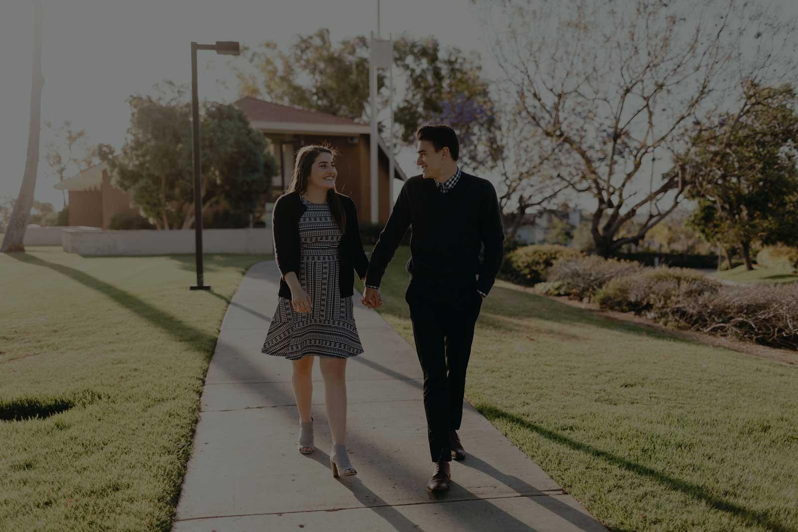 斯科特 and Ariana holding hands walking in front of Good Shepherd Chapel